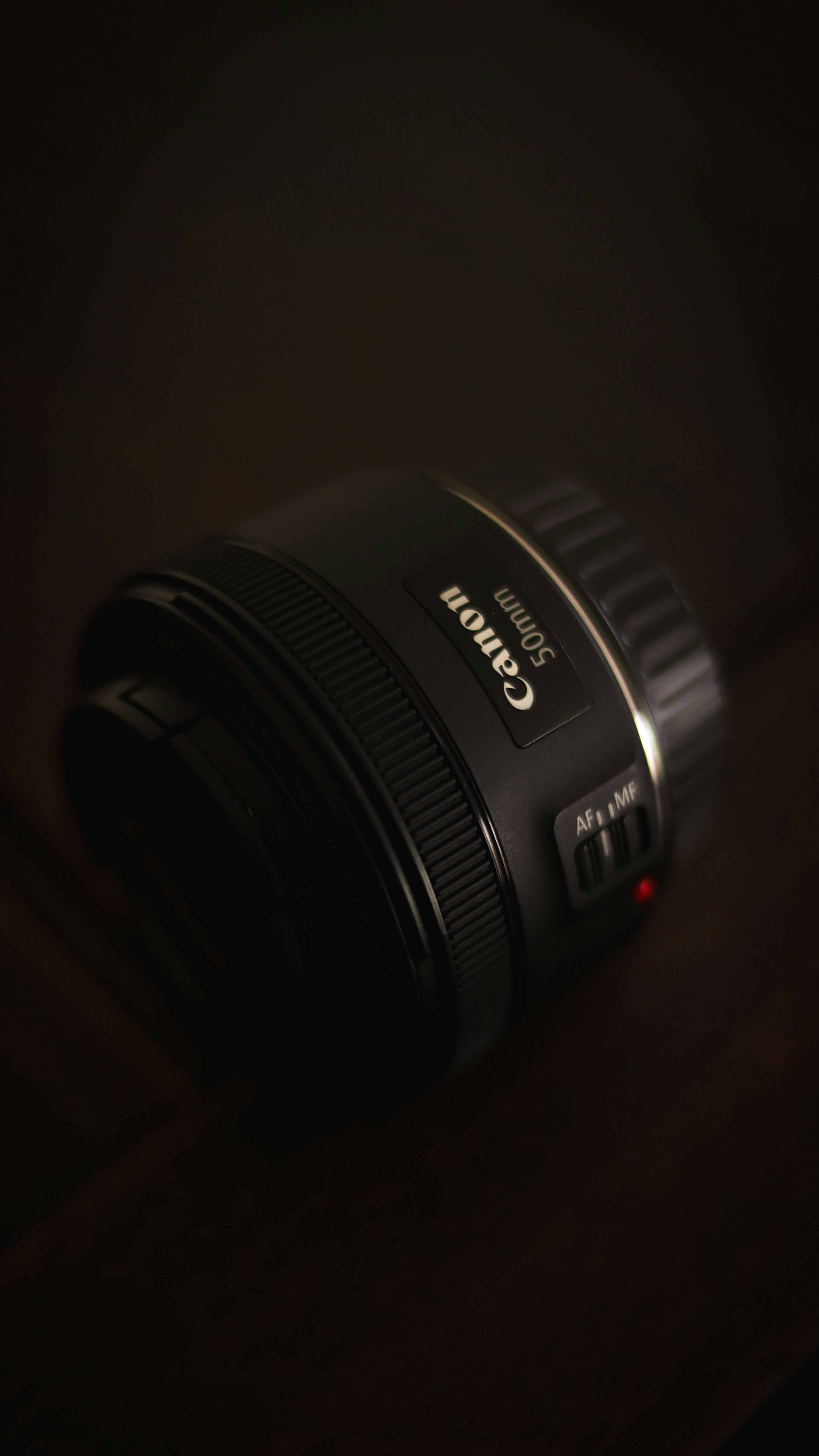 black nikon camera lens on brown wooden table